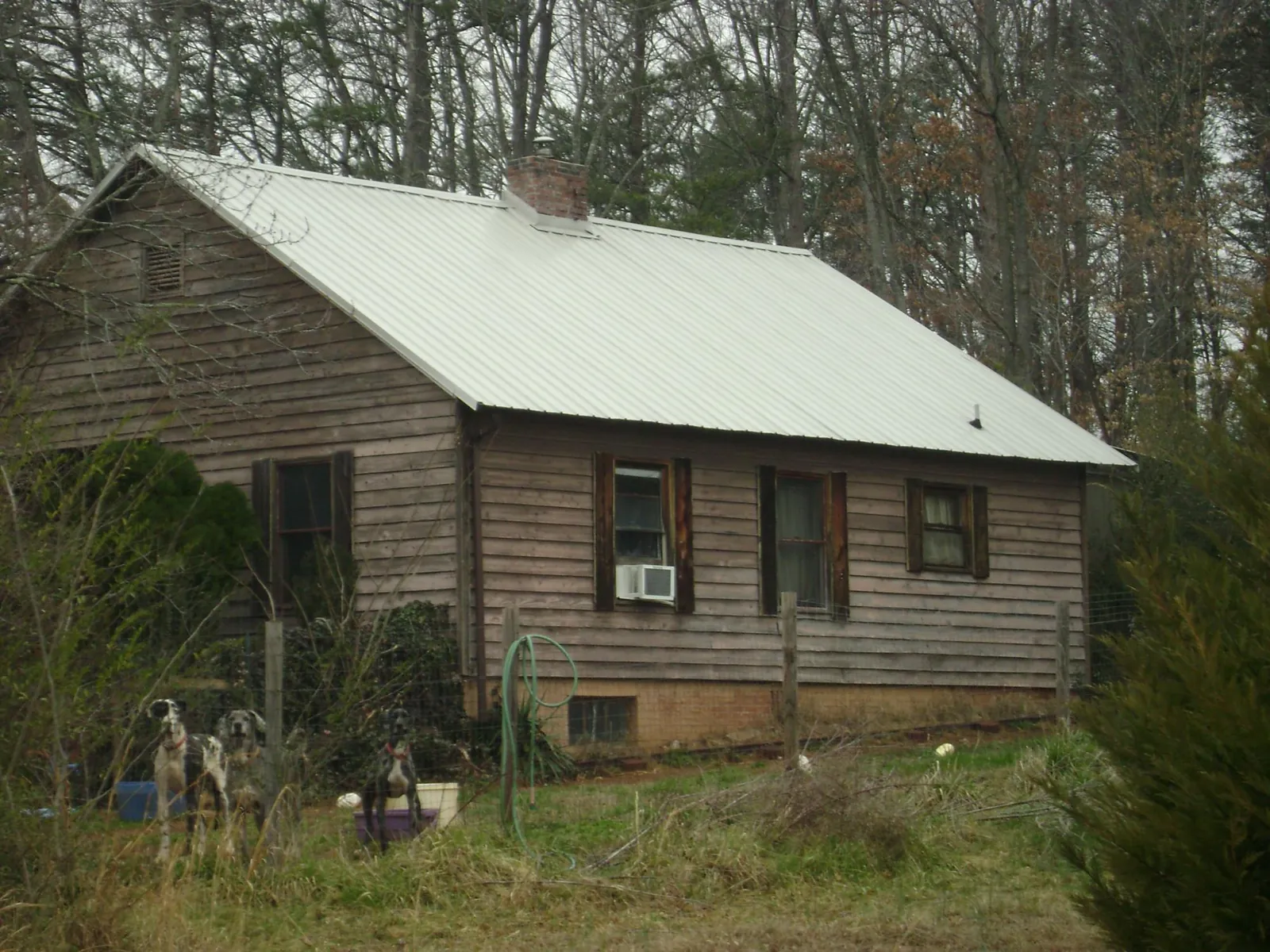 White metal roof on an old wood sided farmhouse, from a Metal Roof Installation job in Pittston